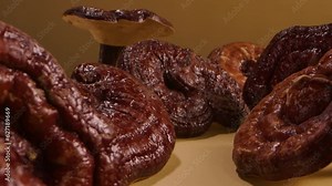 A lot of Lingzhi mushrooms placed on the table with empty space in the middle for product promotion. Lingzhi mushroom (Ganoderma Lucidum) help enhance the immune system