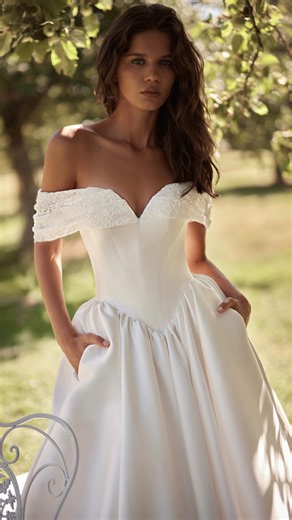 LuceSposa ™ on Instagram: "Elan | Jardin de Lumière A romantic ball gown is made from Mikado fabric. The structured bodice with a sweetheart neckline is decorated with a softly draped lace lapel embellished with sequins. The voluminous skirt features pockets and a long, flowing train. The look can be completed with a lace veil adorned with delicate, manually made embroidery. Discover more via the link in bio."