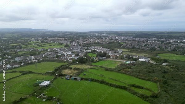 Camborne, Cornwall, England: DRONE VIEWS: The drone ascends and circles around the edge of town. Camborne dates from 1181 and was formerly one of the richest tin mining areas in the world (Clip 2).