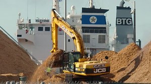 Excavator loading wood-chips onto conveyor belt at the Port of Portland / Portland / Australia January 9, 2019.