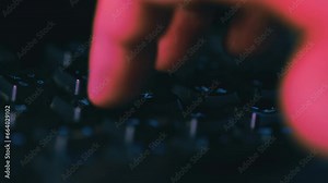 Typing on keyboard macro footage with dark night lights and colours