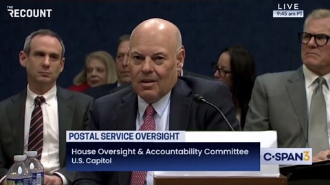 U.S. Postmaster General Louis DeJoy covers his ears during grilling by Rep. Rich McCormick during oversight hearing.