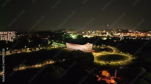 The Parthenon building at night in Nashville, Tennessee with drone video angled moving in wide.