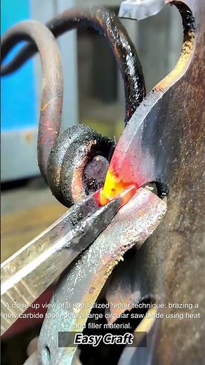 The process of welding a new tooth onto a large carbide saw blade