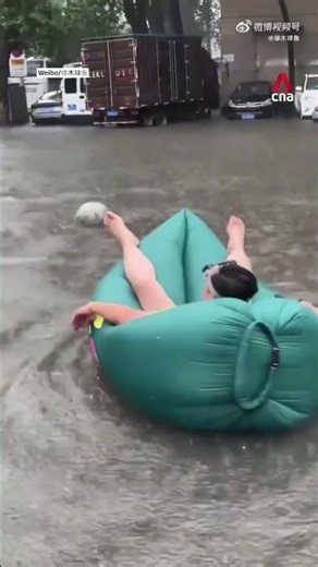 Chinese residents make the most of flooding with water sports, pet rafts