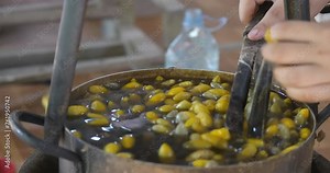 In the hand silk reeling process, cocoons are placed in hot water.