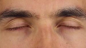 closed eyes of a sleeping person, moving eyeballs under closed eyelids, closeup macro