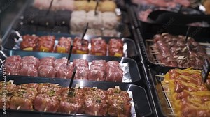 Butcher's counter full of meat skewers and steaks to buy