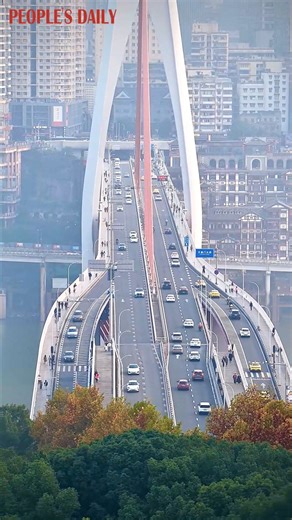 Get a glimpse of the traffic flow across the massive Qiansimen Jialing River Bridge in southwest China's Chongqing. The bridge stretches 720 meters in length with a main span of 312 meters. | People's Daily, China