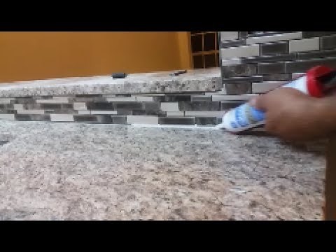 How To Caulk On a Kitchen Backsplash - seal the gap between granite and mosaic.