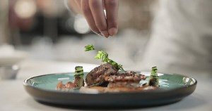 clip-3504712177-restaurant-plate-hand-spices-on-steak-gourmet