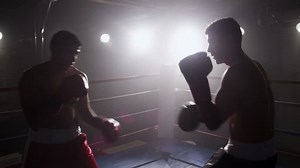 Boxers fight in boxing ring