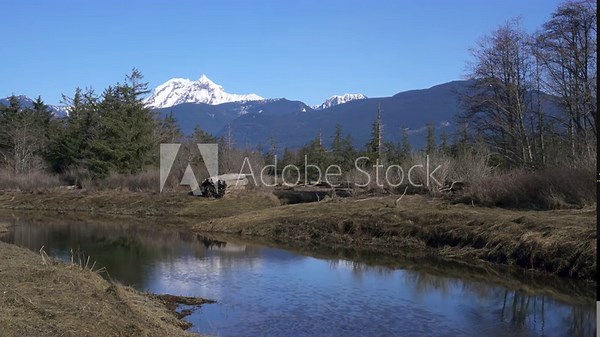 Mt. Garibaldi from the Squamish Estuary 4K UHD. The reflection of Mt. Garibaldi looking over the Squamish Estuary near the mouth of the Squamish River. 4K, UHD.