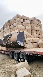 This is the process of unloading hay bales using a wheel loader. | Woodform Crafts