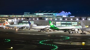 SAN FRANCISCO, CA - 2019: SFO Airport International Terminal Building Architecture Exterior Night Timelapse with Parked Commercial Jet Airplanes Moving from Gates