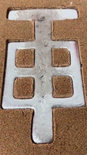 Molten aluminum is poured into dense sand molds to create strong custom tools with precise forms now