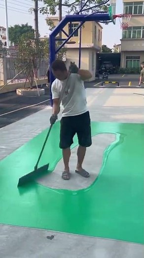 This is the process of applying paint to the cement floor of a basketball court.