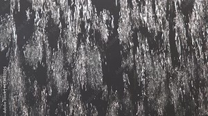 View through the glass on the pouring water. 4K resolution video. Splashes of water droplets on the glass. Window on a heavy rain. Wet glass with large drops of water or rain