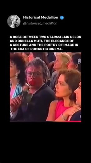 Historical Medallion🎖️ on Instagram: "This frame is not just a random episode from the lives of celebrities, but a carefully calibrated poetic image that became the hallmark of an entire era. In the early 1980s, when cinema still breathed romanticism and stars were surrounded by an aura of inaccessibility, a photographer captured the iconic Alain Delon presenting a rose to the young Italian diva Ornella Muti. The gesture was executed with Delon's signature restraint and light irony. Delon, by t