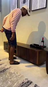 4.5K views · 24 reactions | Revamp your entertainment area with flair using our contemporary black and walnut TV stand. Its sleek angled legs and boxy frame offer a nod to mid-century modern design, while the natural wood grain finish and slatted front doors add a touch of modern sophistication to your living room. | BACH Furniture | Facebook