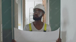 African architect look at blueprint and planning to renovation room.