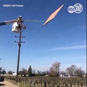 WHAT THE HECK??!! 🤔😲 Over 120 Fresno County homes lost power today... all because of this garage door that somehow got stuck high up in electrical lines near Sanger. CHP officials believe the wind may have been behind this door's very strange journey. Thank you to PG&E officials for bringing it down! | ABC30 Action News