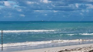 A beautiful Cuban beach in Varadero, Cuba, where you can see the waves and ocean waters on a cloudy day with the sun breaking through the clouds. Turquoise waves. 4K Video Stock Video