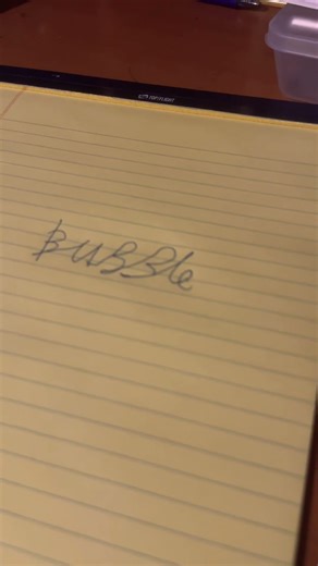 Writing cursive letter bubble on a piece of paper