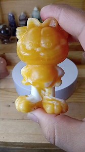Bright orange calcite Garfield carving with bold color #crystalcontent #stonecarving #calcite | Kevin Jay