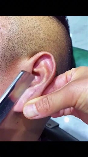 Removing an Earring with Tweezers: A Close-Up Guide