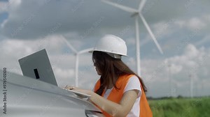 Asian female engineer inspects wind turbine Working on a wind farm Stock Video