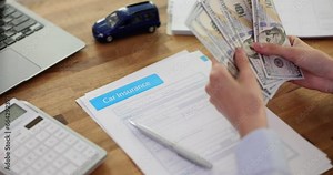 Woman insurance agent hands counting dollars and car insurance application form. Insurance payment compensation road accident