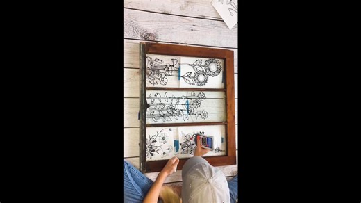 She's using elmers glue & an old window...