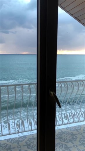 Ocean Waves and Cloudy Skies View from a Window