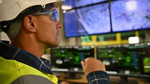 Engineer in Front of Facility Control Room Displays