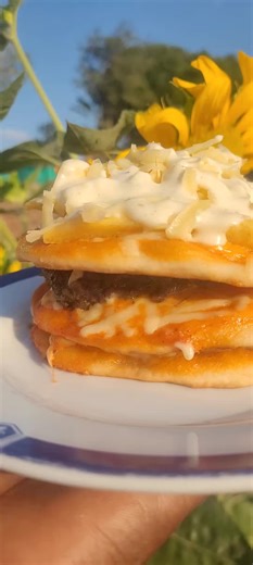 3 pizza buns,2 beef patties (seasoned at the restaurant), each bun topped with restaurant special sauce, & quality mozzarella cheese, top bun topped with fries and more sauce with cheese. #pizzaconcept #musinatiktok❣❣♥️🔥💫 #restaurant #foodie