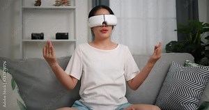 Footage zoom in shot, Relaxed young woman wear VR goggles doing yoga and meditation enjoying rest on sofa in living room at home, breathing fresh air, Stock Video