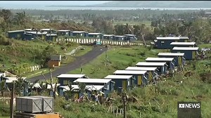 Fiji's Prime Minister has announced new vaccine requirements and on the spot fines in a bid to control a surge of Delta-fuelled coronavirus cases. The government now requires all civil servants, private sector employees and employers to get vaccinated if they want to keep working. As Pacific affairs reporter Liam Fox explains, a Fijian village is also doing its best to protect residents. | ABC Pacific