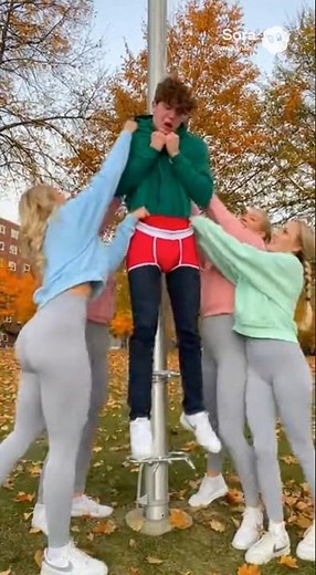 Group of popular blonde girls give nerd a flagpole wedgie