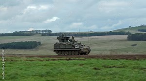 British army Stormer tank equipped with Starstreak HVM (High Velocity Missile) launcher, travelling at speed across countryside