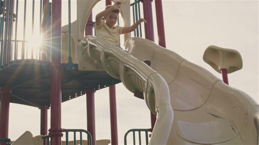 Slide in a park with children sliding down - Free Stock Video