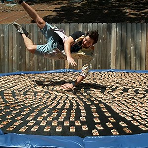 Slow-Mo Video of a Man Diving Onto a Trampoline Covered in Loaded Mousetraps  - Core77