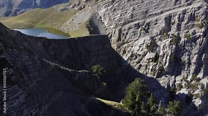 Aerial drone video from iconic and beautiful lake Drakolimni of Tymfi mountain which resides at high altitude above sea, Vikos National Park, Zagori, Greece