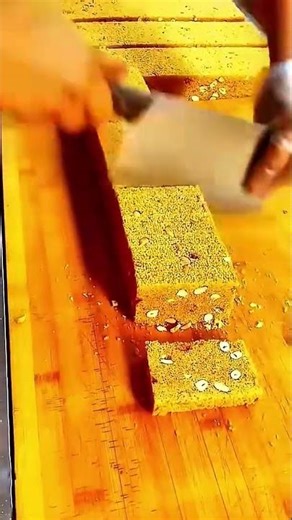 Cleaver slicing golden nut brittle clean cuts on cutting board #shorts