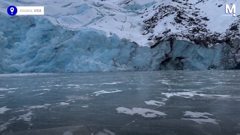Glacier breaks and crashes into frozen lake in Alaska