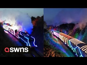 Train covered in CHRISTMAS LIGHTS winds through UK village 🚂 | SWNS