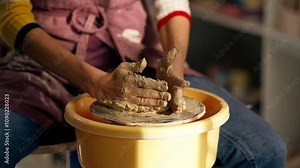 close up hands in clay modeling studio young girl hands giving shape to clay on a potter's wheel applied art clayware old craftsmanship mechanical potter's wheel