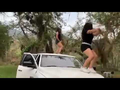 Two girls dancing on car