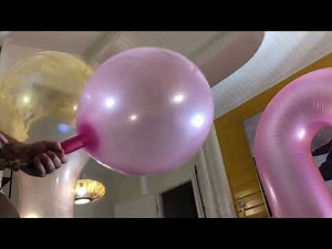 Filling big pink balloon with helium