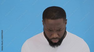 Furious dark skinned male screams loudly, annoyed with interlocutor, expresses negative emotions and feelings, keeps mouth widely opened. Angry African boss shouts at coworkers, being strict 4K